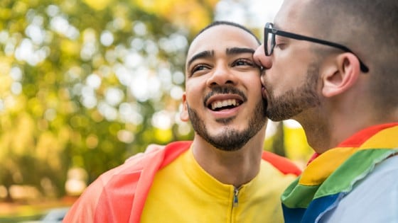 Two persons kissing on the cheek